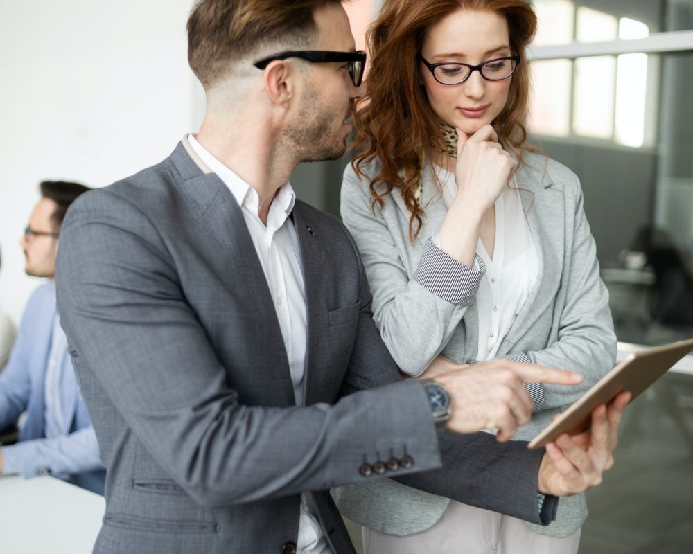 group-of-lawyers-discussing-contract-together-in-office.jpg